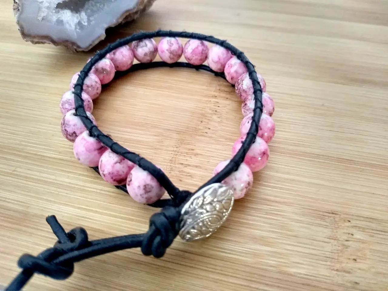 Bohemian style black leather bracelet with rhodonite beads.