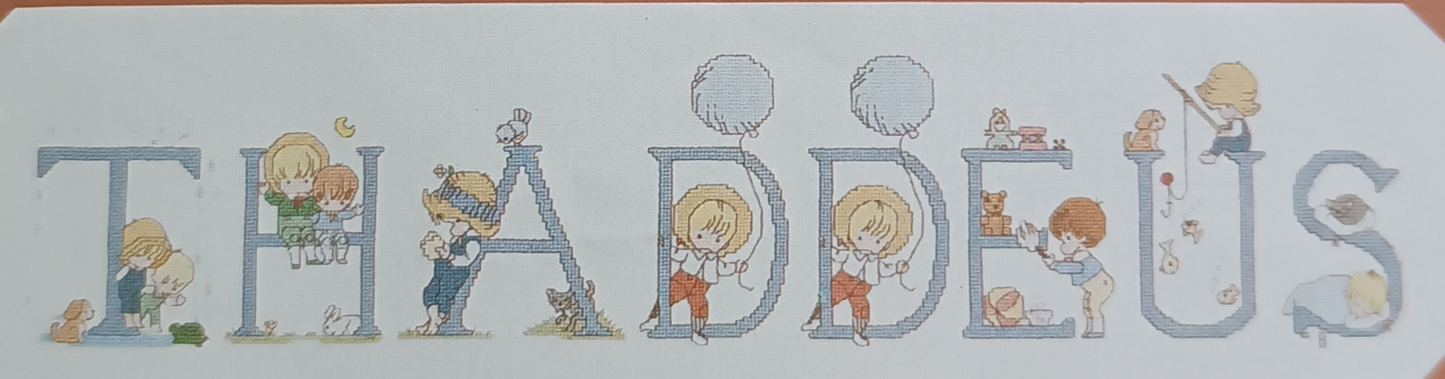 Graphic and pattern of the complete alphabet of 52 cross-stitch letters with designs for boys and girls