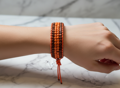 Pulsera de cuero con cuentas de madera naranja y marrón.