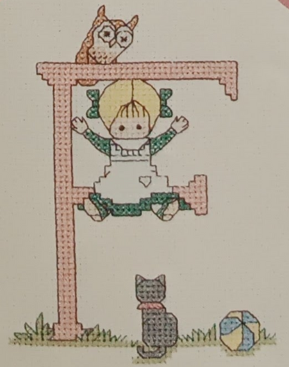 Graphic and pattern of the complete alphabet of 52 cross-stitch letters with designs for boys and girls