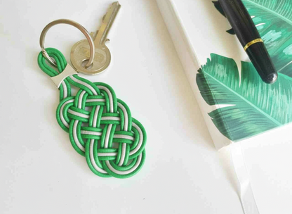 Keychain of braided knots with the Celtic symbol in two colors