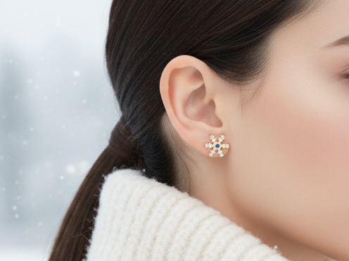 Pendientes de botón con adorno de copo de nieve, con cristal central en tonos azules.